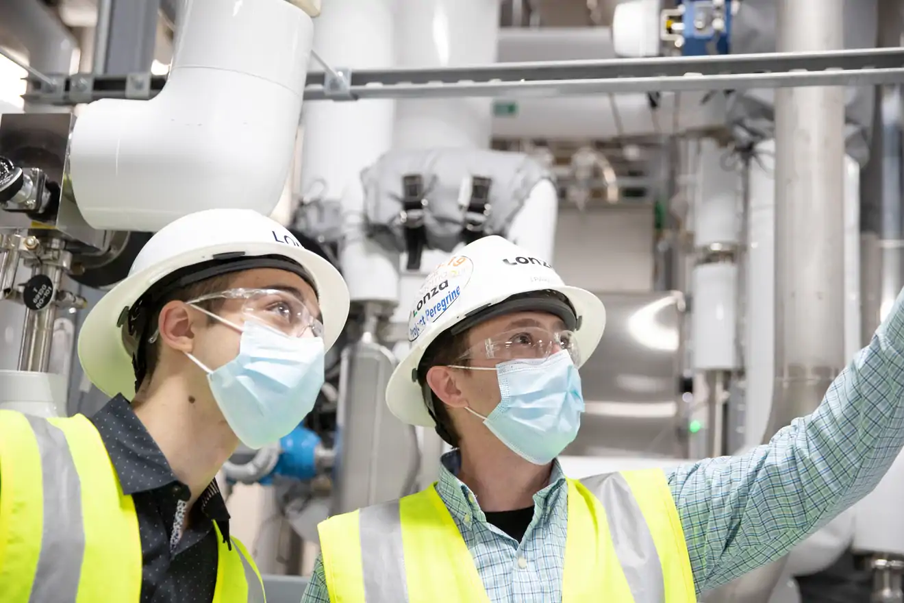 two men in safety vest and hard hats