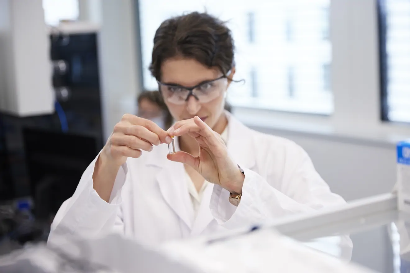 woman looking at vial