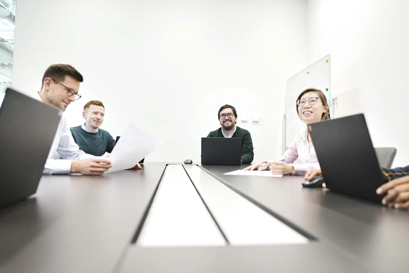 Employees at meeting table