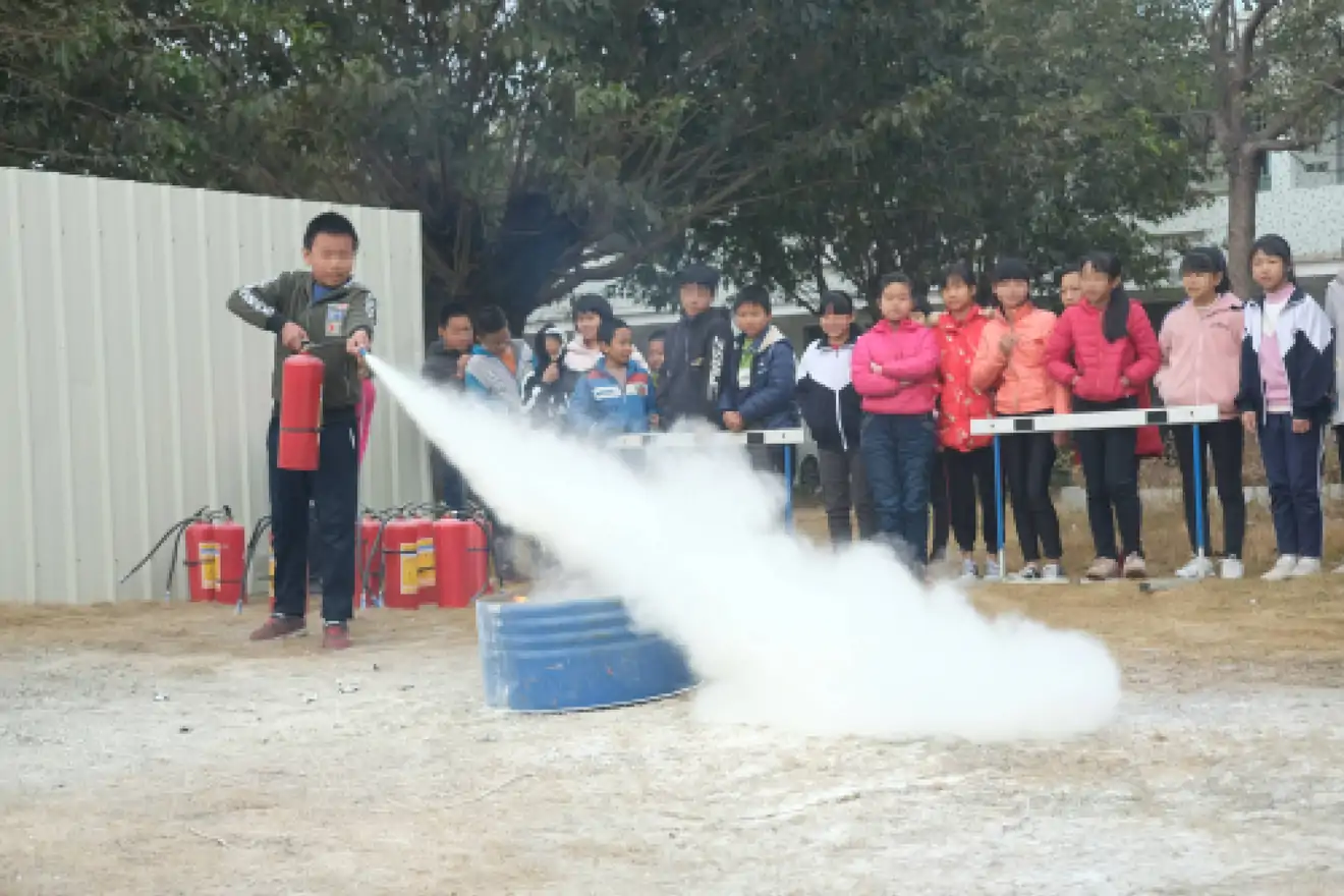children training to use fire extinguisher