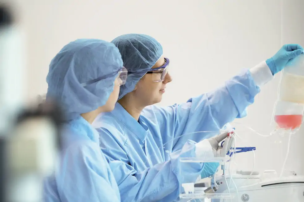 female techs holding fluid bag